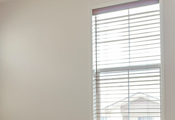 Bright living room adorned with sleek horizontal faux wood blinds