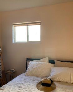 Bright and inviting bedroom in Berkeley featuring a freshly installed custom window shade on the window, combining style and functionality.