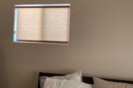 Custom pull down window shades completely closed on a Berkeley bedroom window, providing maximum privacy and subtle room darkening.